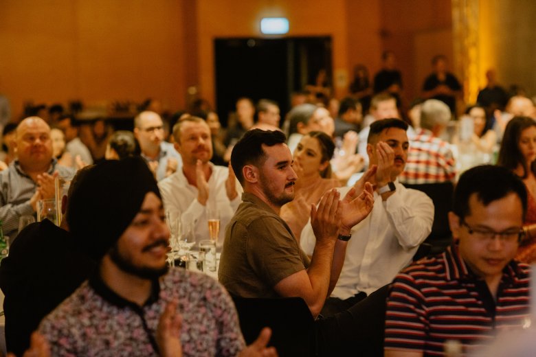 People clapping at an event 