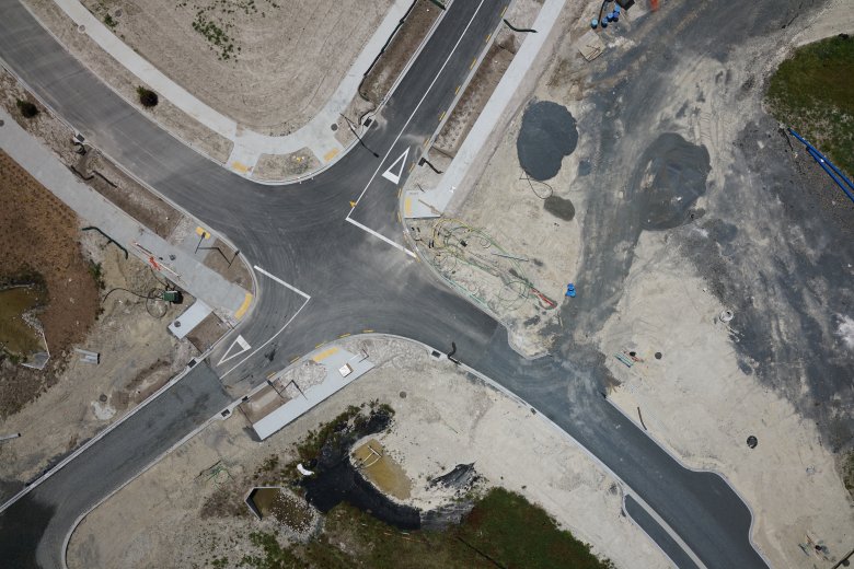 Aerial drone shot of road construction in subdivision