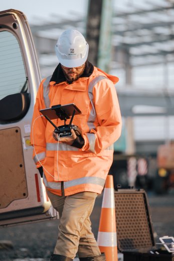 Drone operator lookin at remote control unit