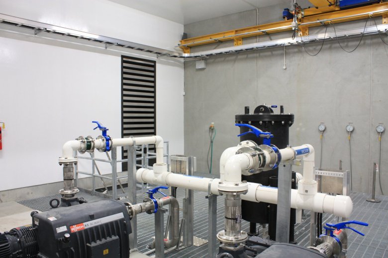 Internal view of pumping station with pipes and valves 