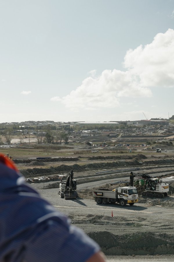 Site construction outlook with two workers in close foreground