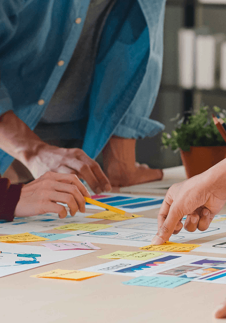 Image of hands working on plans