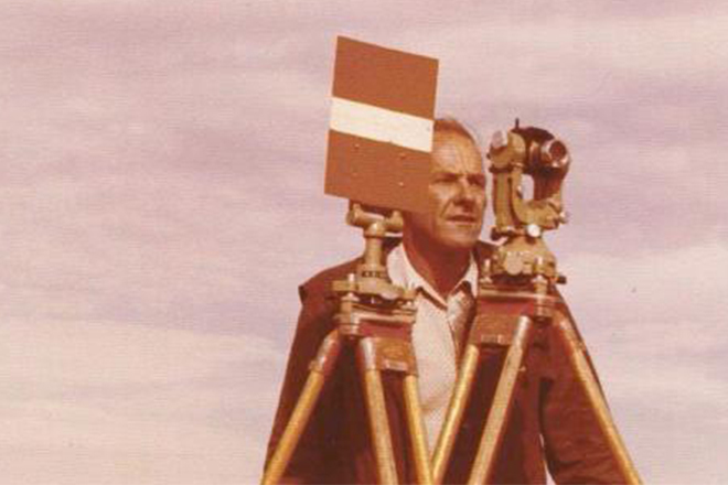 Man with old surveying equipment