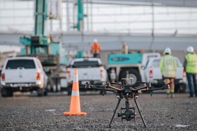 Drone landed with construction site in background