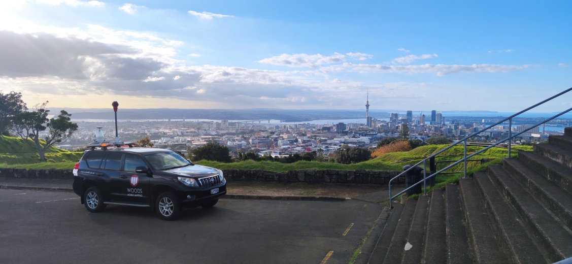 Mobile laser scanning vehicle atop Auckland mountain city view in background